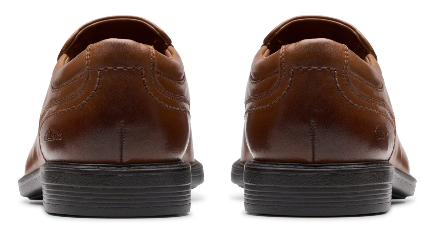 Two brown dress shoes, back view.