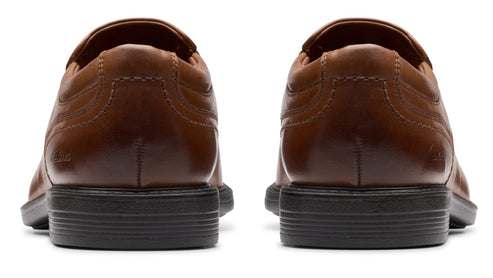 Two brown dress shoes, back view.