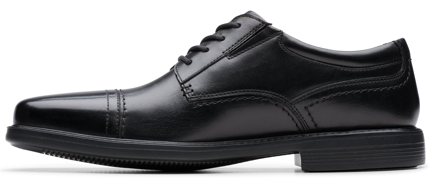A black leather dress shoe with a lace-up closure.