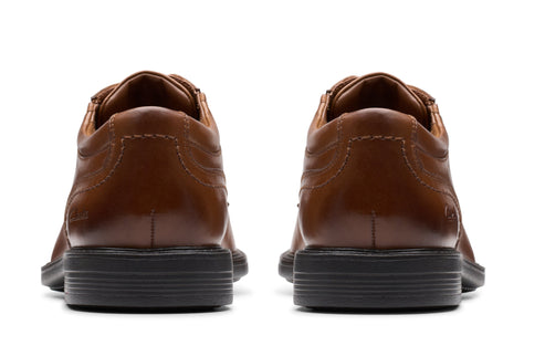 Pair of brown leather dress shoes, seen from behind.