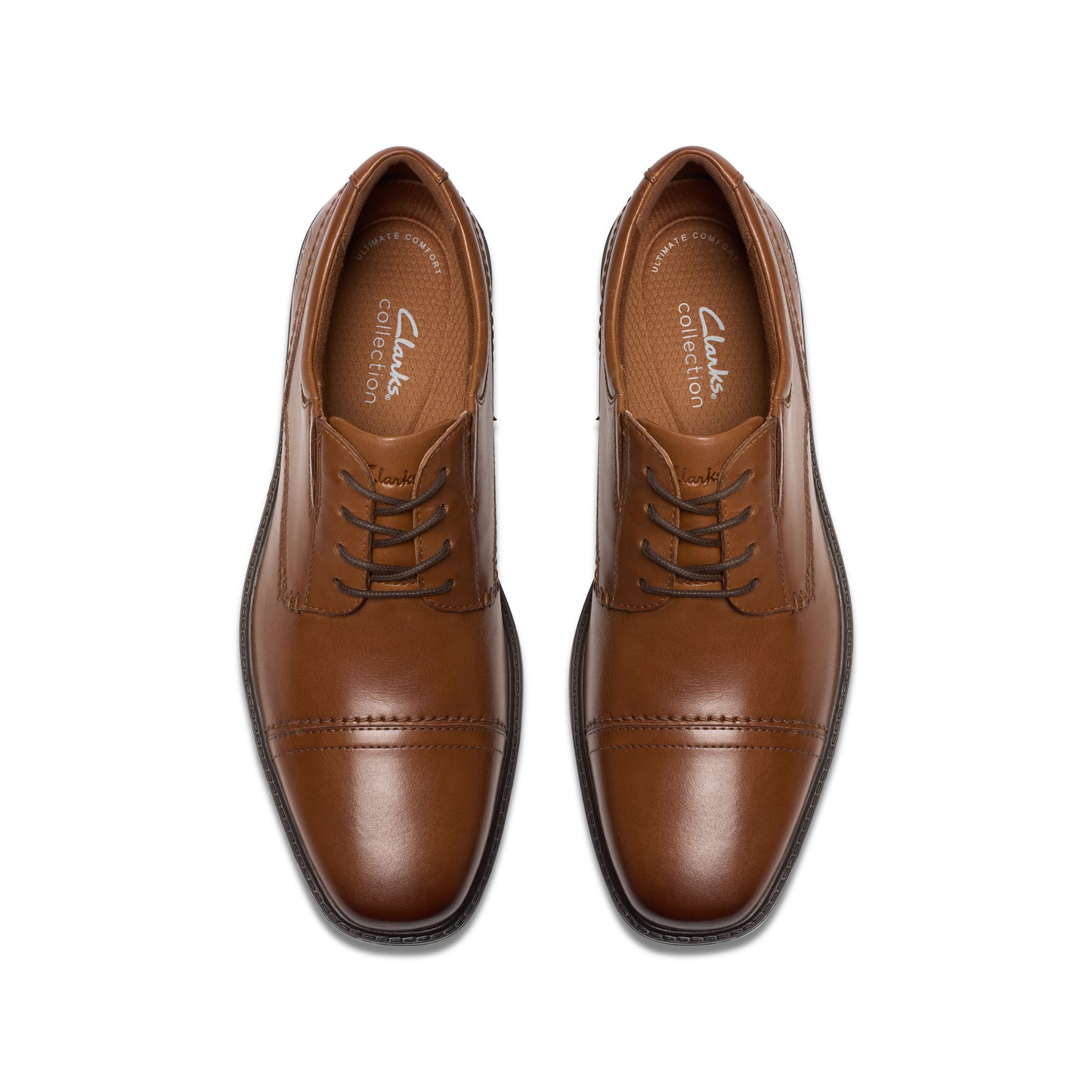 Pair of tan leather dress shoes with lace-up closure.