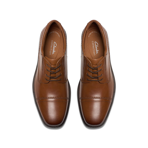Pair of tan leather dress shoes with lace-up closure.