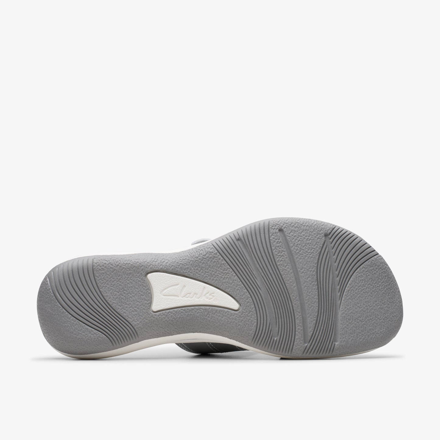 Sole of sandal with brand mark and wavy lines.