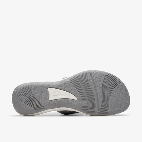 Sole of sandal with brand mark and wavy lines.