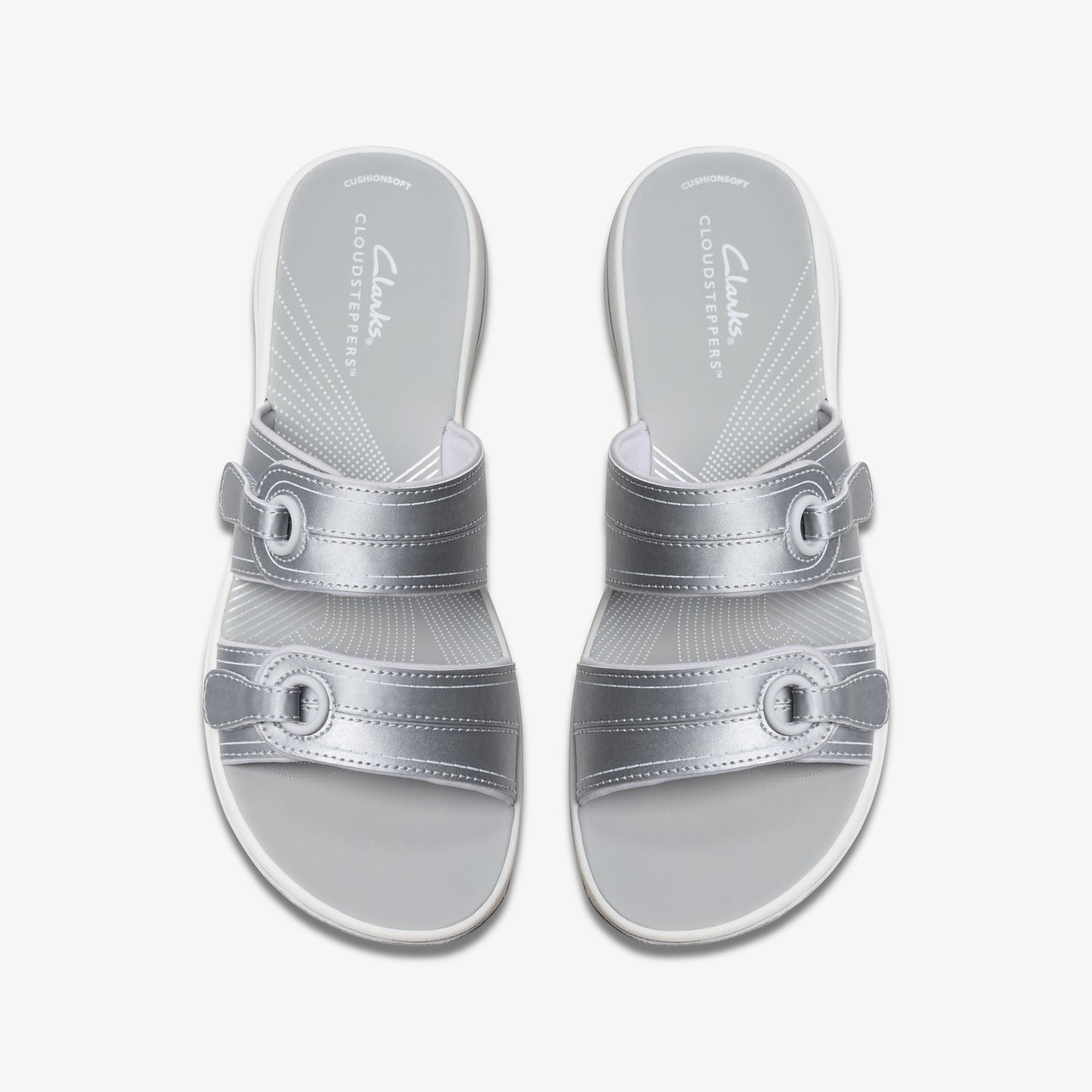 Pair of silver adjustable slide sandals with white soles.
