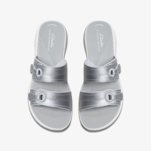 Pair of silver adjustable slide sandals with white soles.
