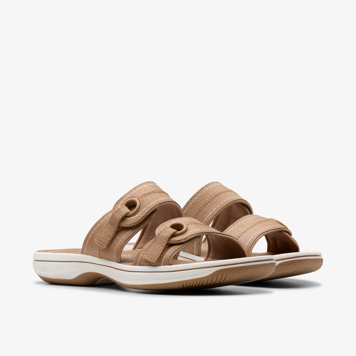 Pair of beige sandals with white soles and two adjustable straps.