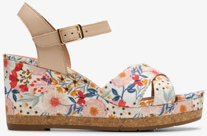 Floral wedge sandal with adjustable ankle strap.