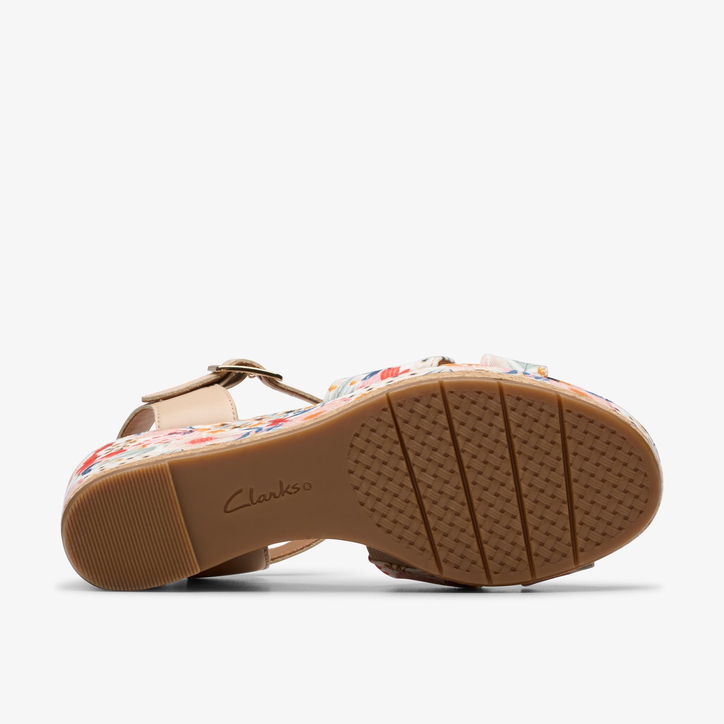 Low wedge sandal with a beige leather ankle strap, a closed toe covered in a floral print, and a brown sole with the name 'Clarks' imprinted in the center.