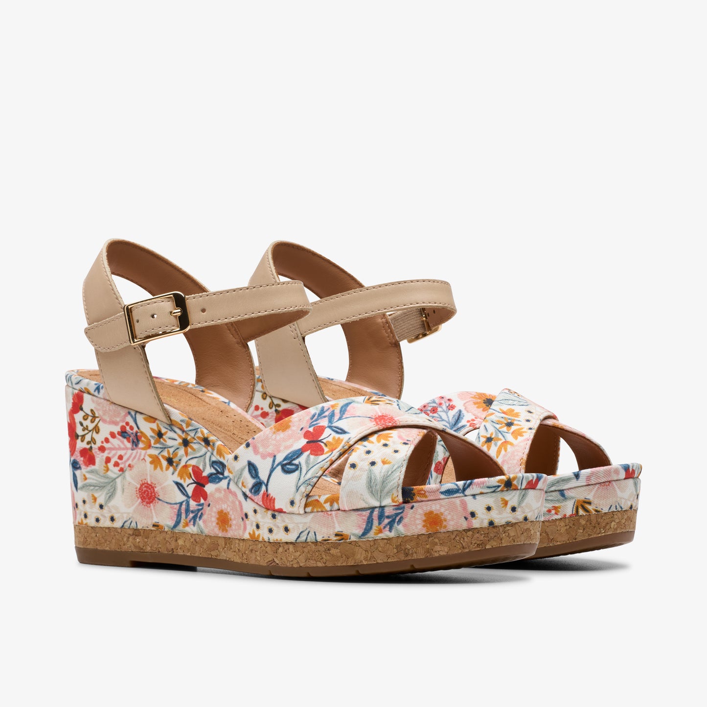 Floral wedge sandals with beige straps and buckle.