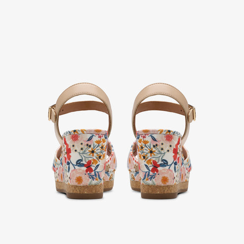 Floral pattern platform sandals with beige ankle straps, rear view.