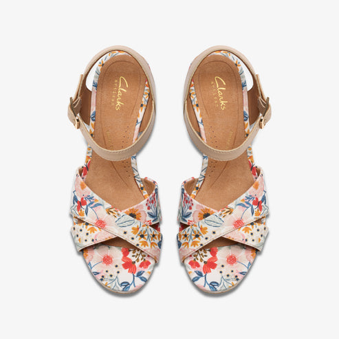 Floral print sandals with an ankle strap and cross-over straps.