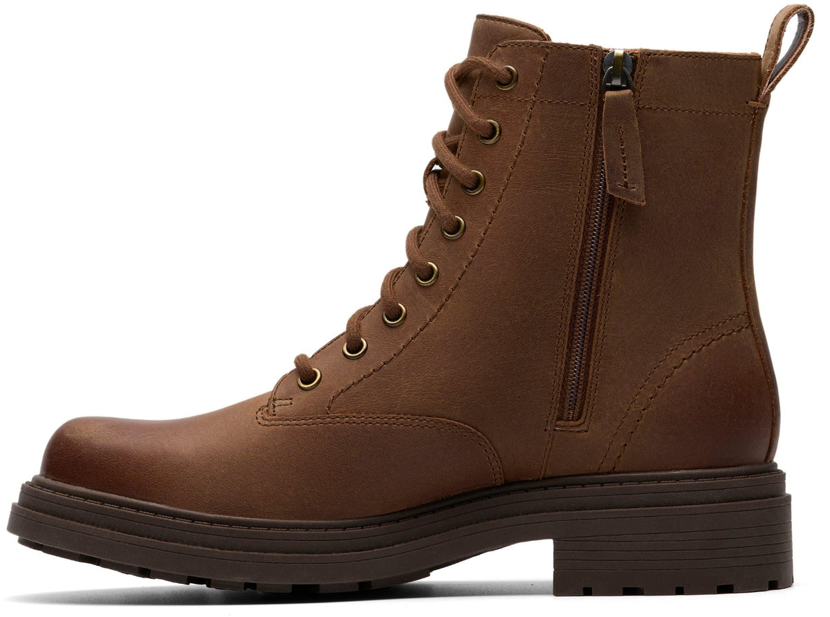 Brown leather lace-up boot with side zipper and lug sole.