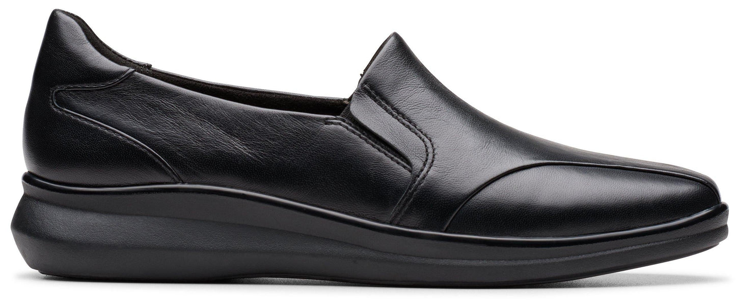 A black, slip-on women's shoe with a low wedge heel.