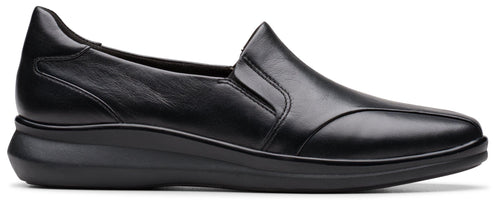 A black, slip-on women's shoe with a low wedge heel.