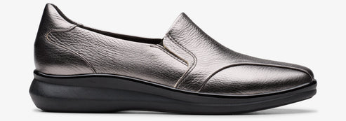 A silver, slip-on shoe with a dark sole.