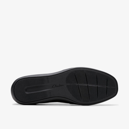 Bottom view of a black shoe featuring a dark sole with a textured pattern.