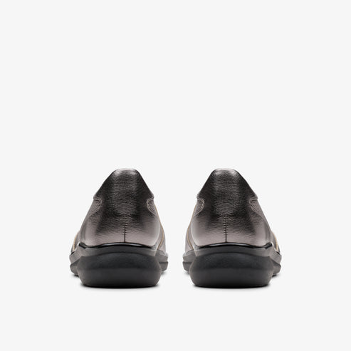 Pair of low-heeled metallic silver shoes, rear view.