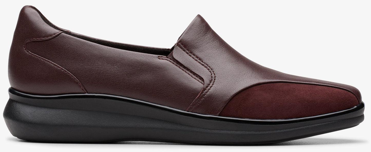 A burgundy leather slip-on shoe with a black sole.