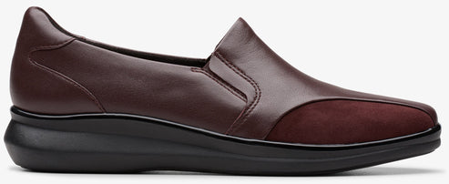 A burgundy leather slip-on shoe with a black sole.