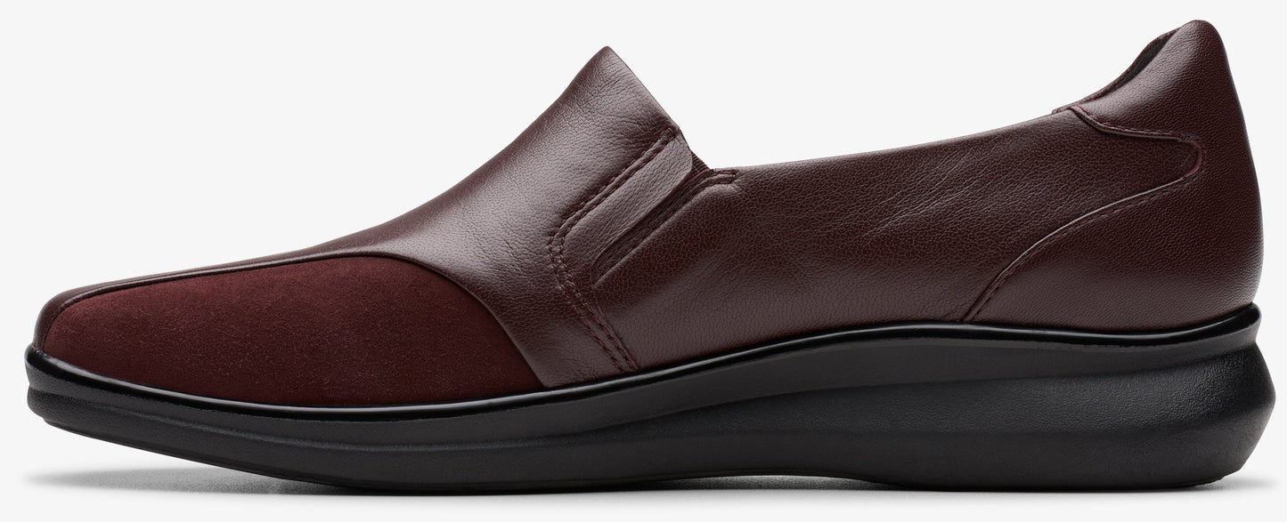Burgundy slip-on shoe with a black sole.