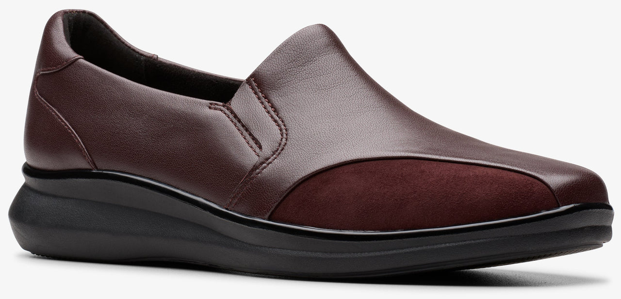 Burgundy slip-on shoe with a leather upper and a low wedge heel.