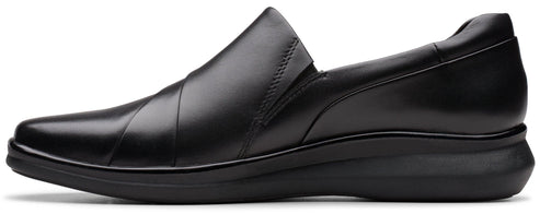 A black leather slip-on shoe with a flat, cushioned sole.