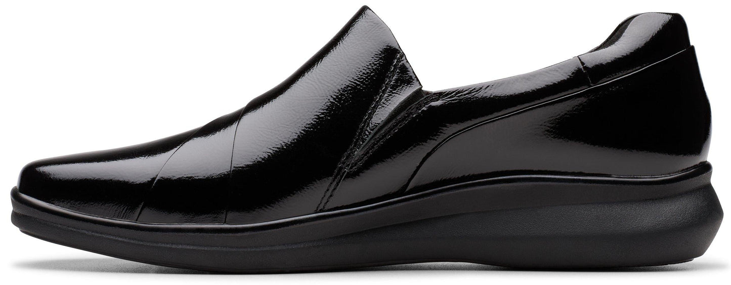 Black patent leather slip-on shoe with a low heel.