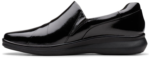 Black patent leather slip-on shoe with a low heel.
