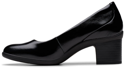 Side view of black patent leather heeled pump with round toe and block heel.