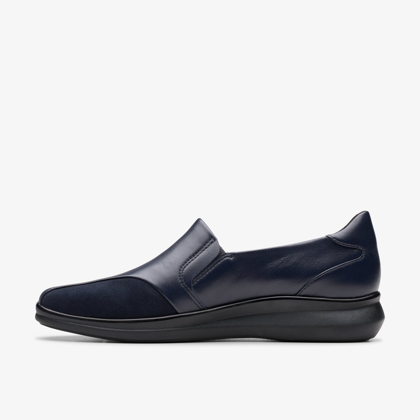 Navy slip-on shoe with leather and suede details, and a low black sole.