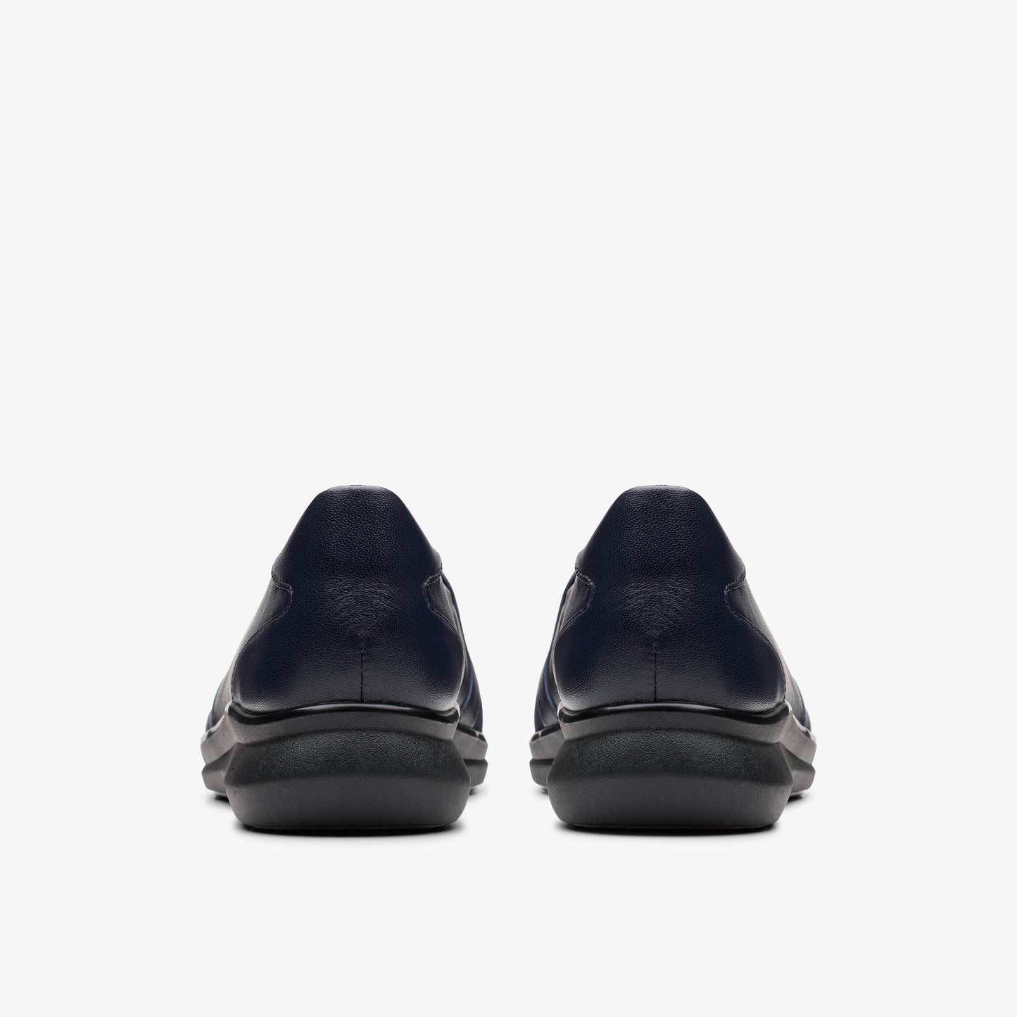 Pair of navy blue slip-on shoes, back view.