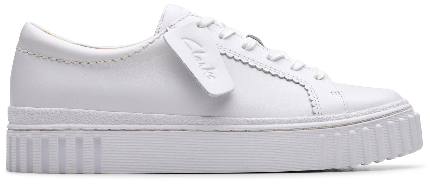 A white shoe with a thick, ridged sole and laces.