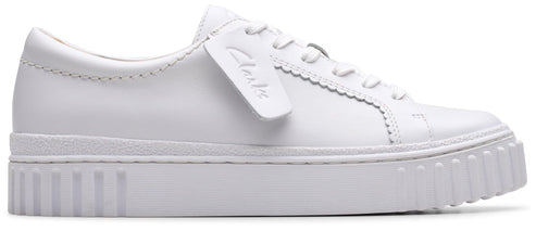 A white shoe with a thick, ridged sole and laces.