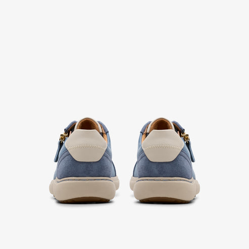 Rear view of two blue suede sneakers with off-white heel patches and tan soles.