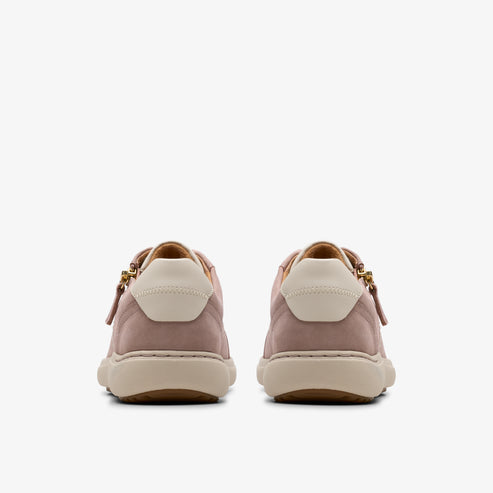 Rear view of pink suede sneakers with off-white heel patch and beige sole.