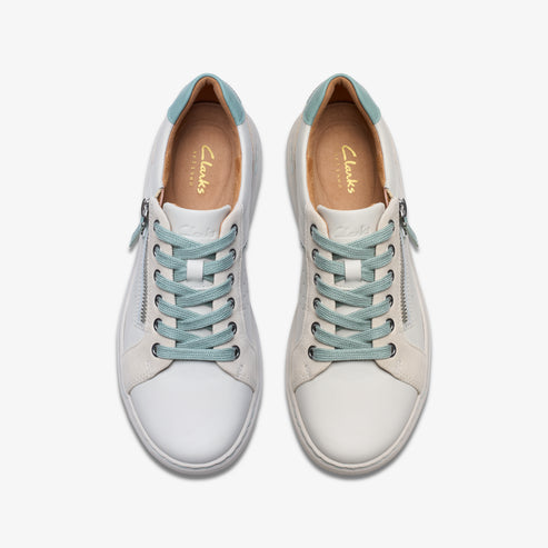 Overhead view of white lace-up shoes with zipper and light blue laces and interior.