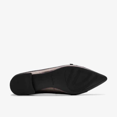Close-up of a shoe showing a black sole with curvy treads.