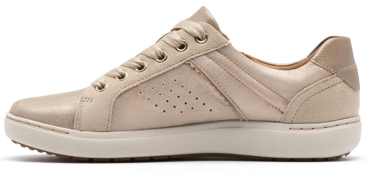 A woman's light-colored leather sneaker with a white rubber sole.