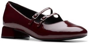 Burgundy patent leather Mary Jane shoe with two straps and buckle closure.