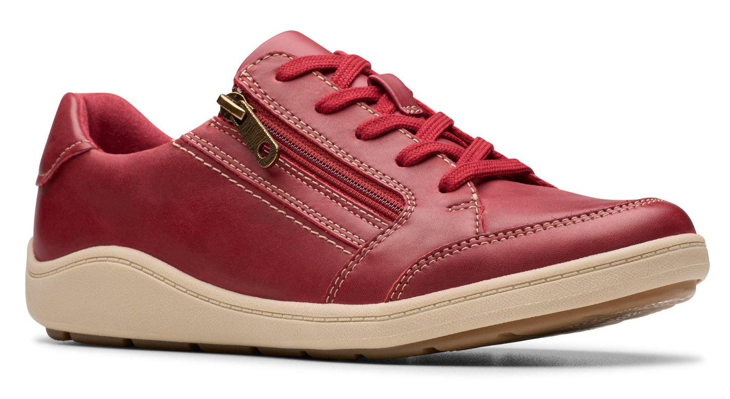 Red leather casual shoe with laces and a side zipper on a tan sole.