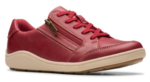 Red leather casual shoe with laces and a side zipper on a tan sole.