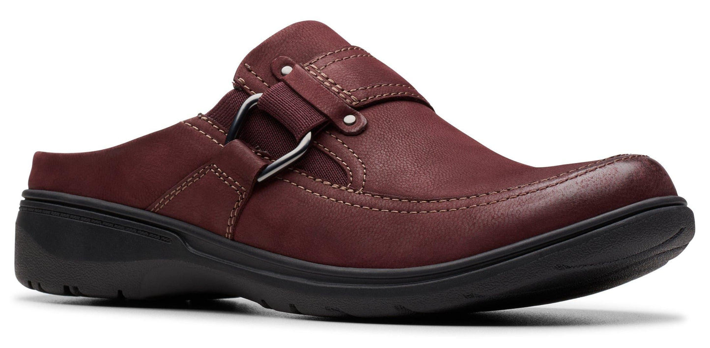 A burgundy leather slip-on shoe with a black sole and a decorative silver ring.
