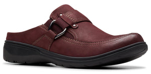 A burgundy leather slip-on shoe with a black sole and a decorative silver ring.