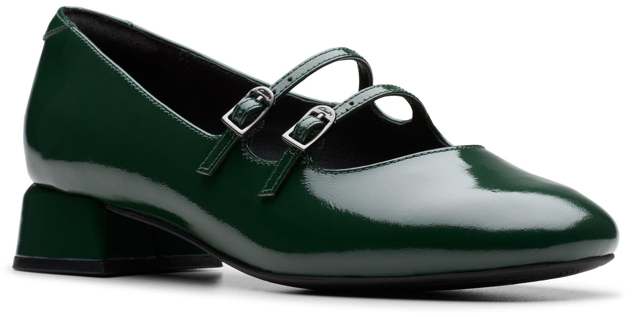 Green shiny shoe with two buckled straps.