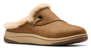 Tan slip-on shoe with faux fur trim and a flat sole.