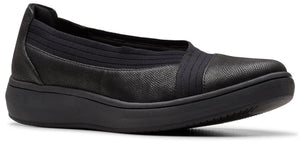 A black slip-on shoe with a low wedge heel.