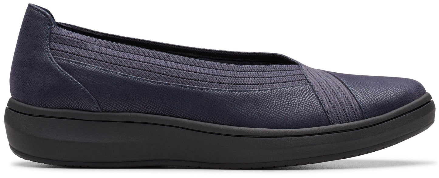 Slip-on shoe with dark-colored sole and navy upper.