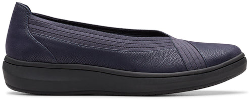 Slip-on shoe with dark-colored sole and navy upper.