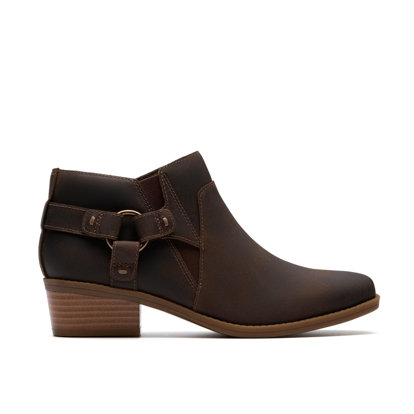 Side view of dark brown ankle boot with ring accent and low heel.